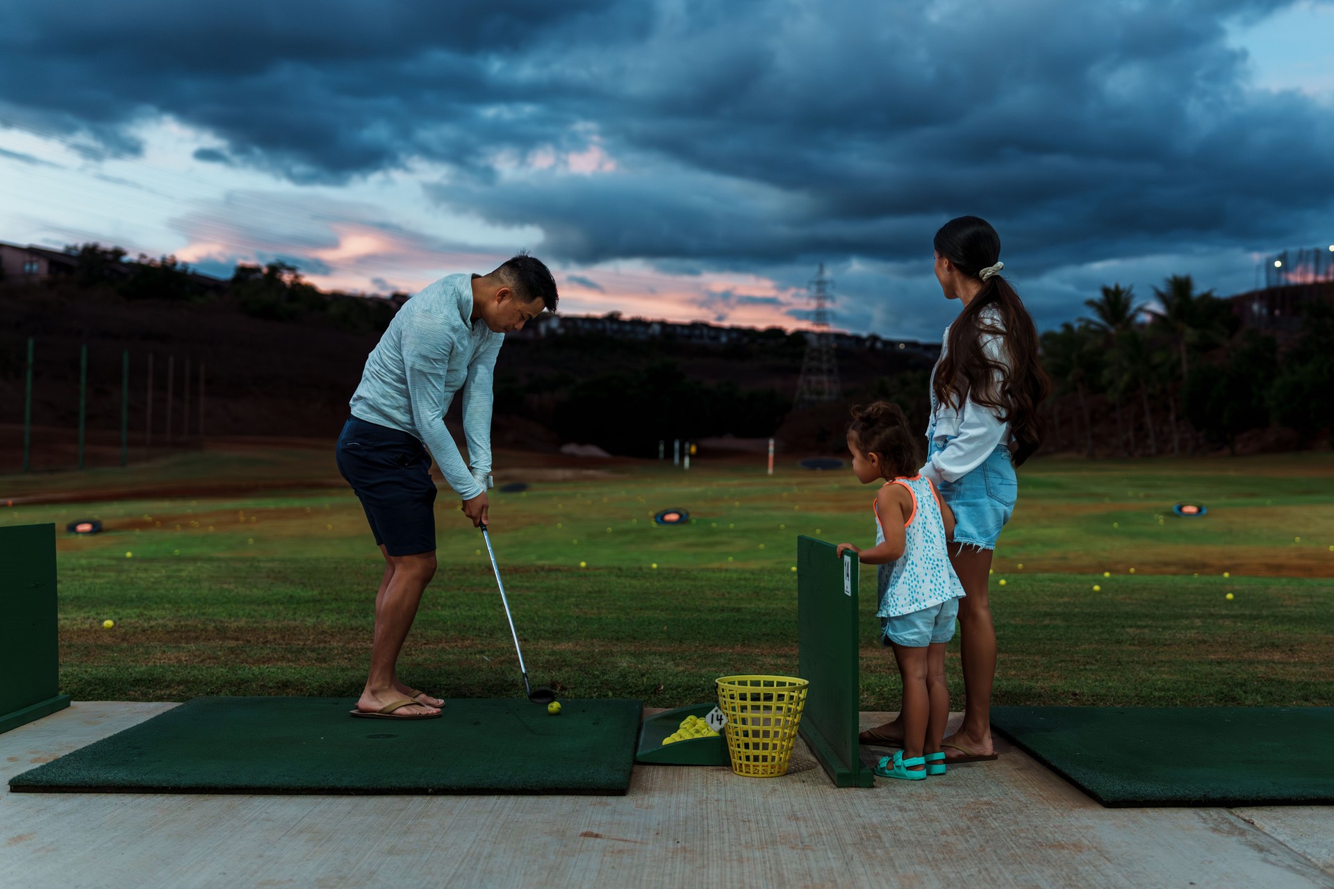 Family having fun a the golfing range